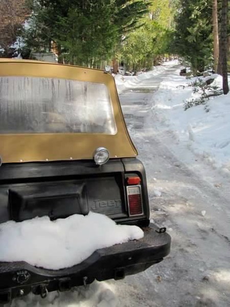 a fine photo of a 1973 jeep commando in the snow